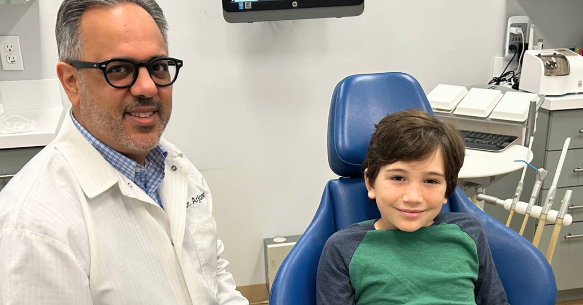 Dentist-and-child-in-a-dental-office-with-equipment-in-the-background