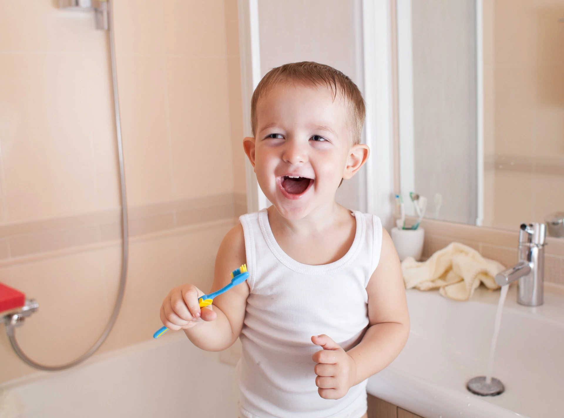 kid or child brushing teeth in bathroom